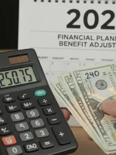Hands calculating a 3.2% increase on monthly payments for SSI 2026.