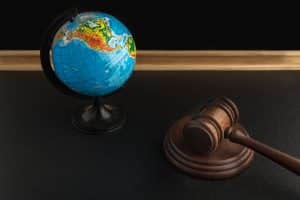 AI deepfake legislation: Wooden Judge gavel and globe. 